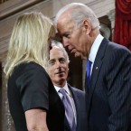 Vice President Joe Biden whispers to Sen. Bob Corker's wife. The senator does not appear to be delighted by this interaction.