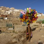A man wanders through Kabul trying to sell his balloons on Oct. 17, 2011.