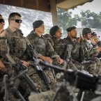 Afghan soldiers sit alongside U.S. soldiers during a pre-patrol briefing in Afghanistan on June 26, 2012.