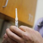 A doctor prepares to give the flu vaccine to a New Yorker in a walk-in clinic on Jan. 10.