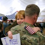 A child hugs his father, who returned from Afghanistan on Nov. 4, 2012, after a nine-month deployment.