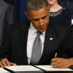 President Obama, flanked by kids who wrote to him after the Sandy Hook massacre, signs an executive order on gun control on Jan. 16.