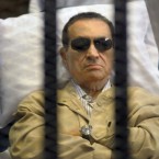 Hosni Mubarak lays on a gurney inside the police academy courthouse in Cairo on June 2, 2012.