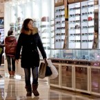A woman shops in a Beijing mall: "The economy has officially exited its slowdown," Chinese officials said.