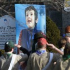 Boy Scouts salute a funeral procession for Benjamin Wheeler, 6, who was killed in the Sandy Hook massacre.
