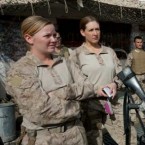 U.S. Marines, including Lance Corporal Kristi Baker (left) and Hospital Corpsman Shannon Crowley (right), listen to a briefing before heading out on patrol.